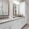 bathroom area with duo sinks and mirrors, and a stylish faucet