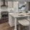 Kitchen with island, tile backsplash and granite countertop.